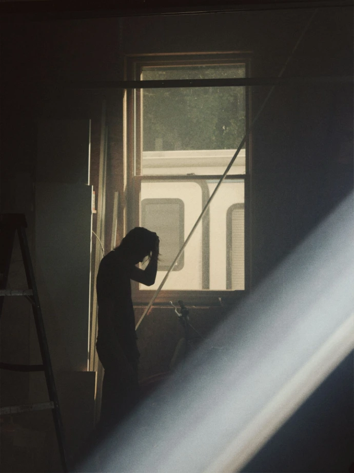 man by a window